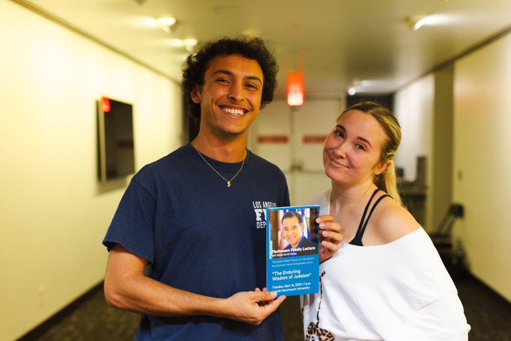 Students pose with the program at the event